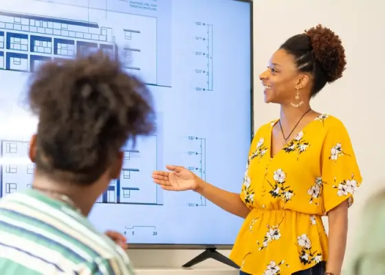 Woman smiling and looking at a large television screen