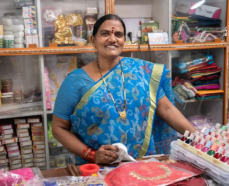Indian woman standing behind a desk in a store