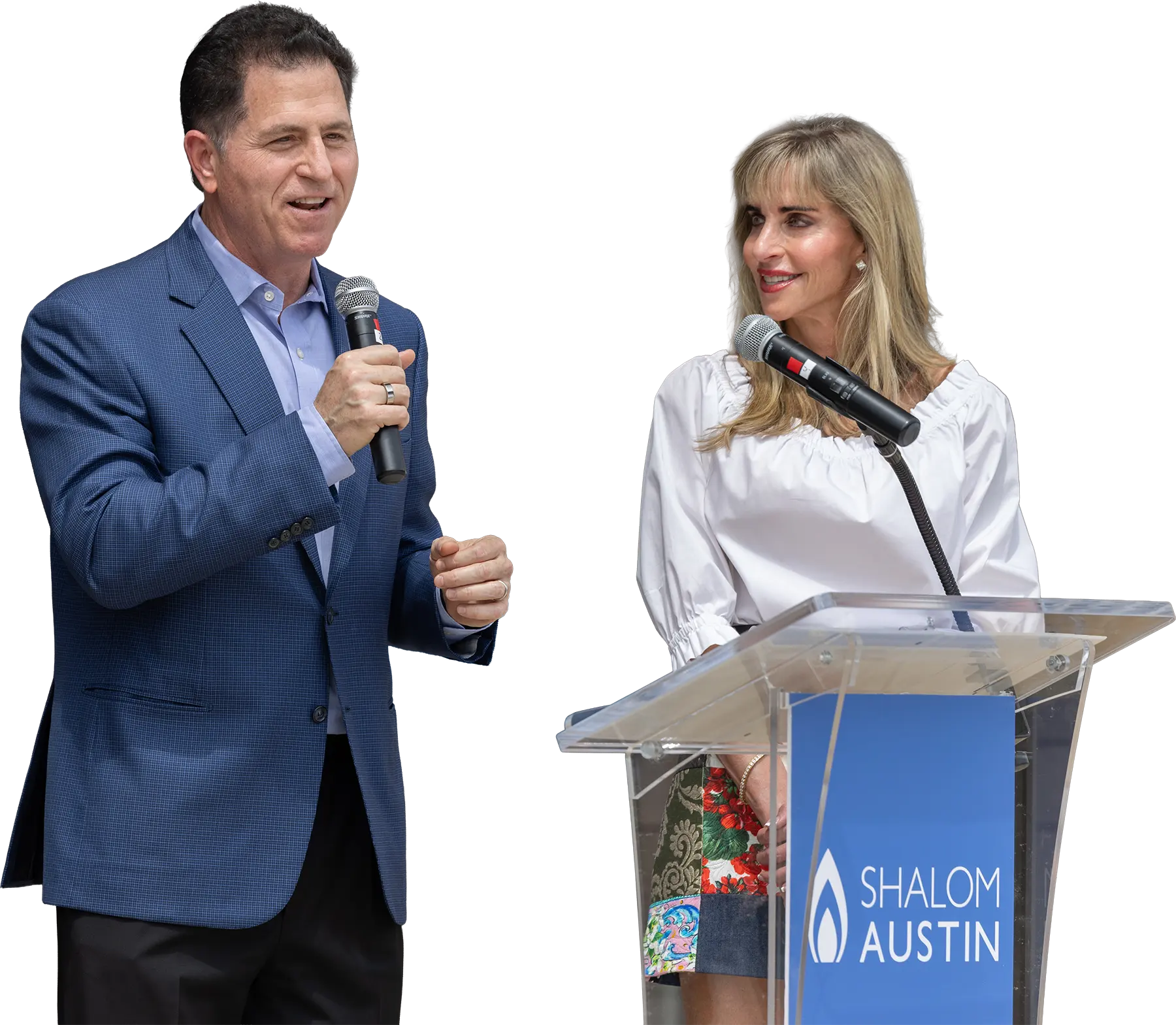 Michael and Susan speaking on stage at an event in Austin, TX.